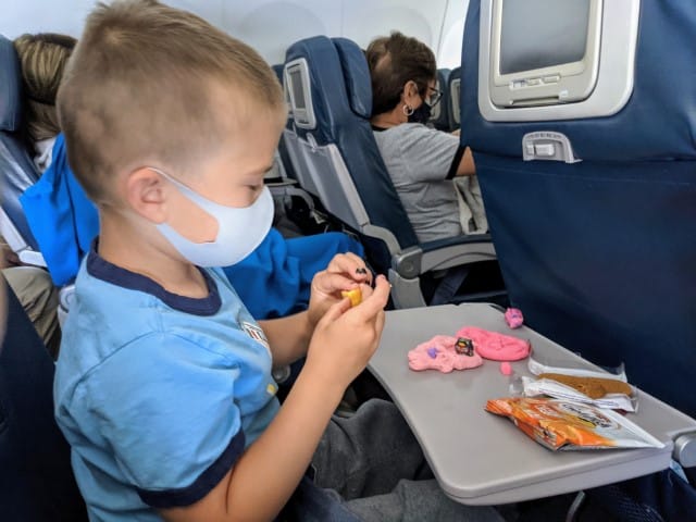 Child playing with lost kitties toys on the airplane