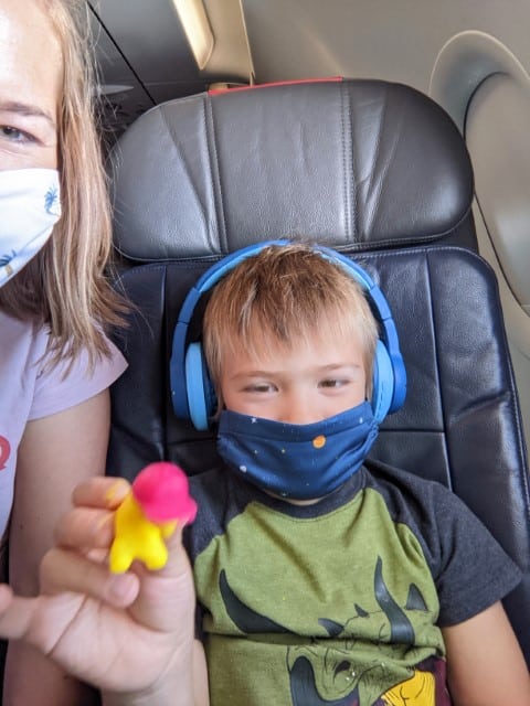 Playing with Play-Doh on the airplane.  Traveling during the pandemic means always having a mask. 