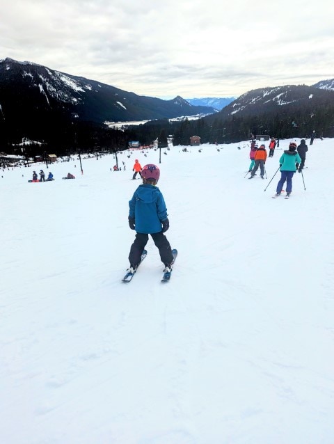 A child skiing down a small hill